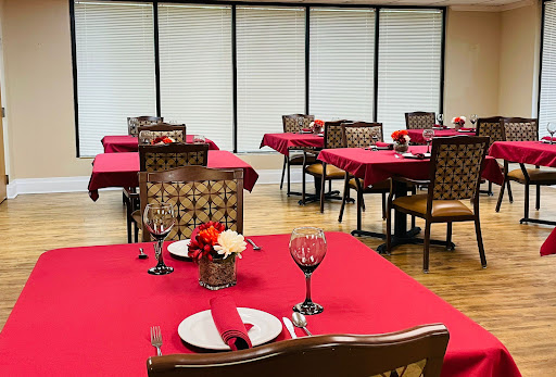 Elegant dining setup with red tablecloths and inviting decor.