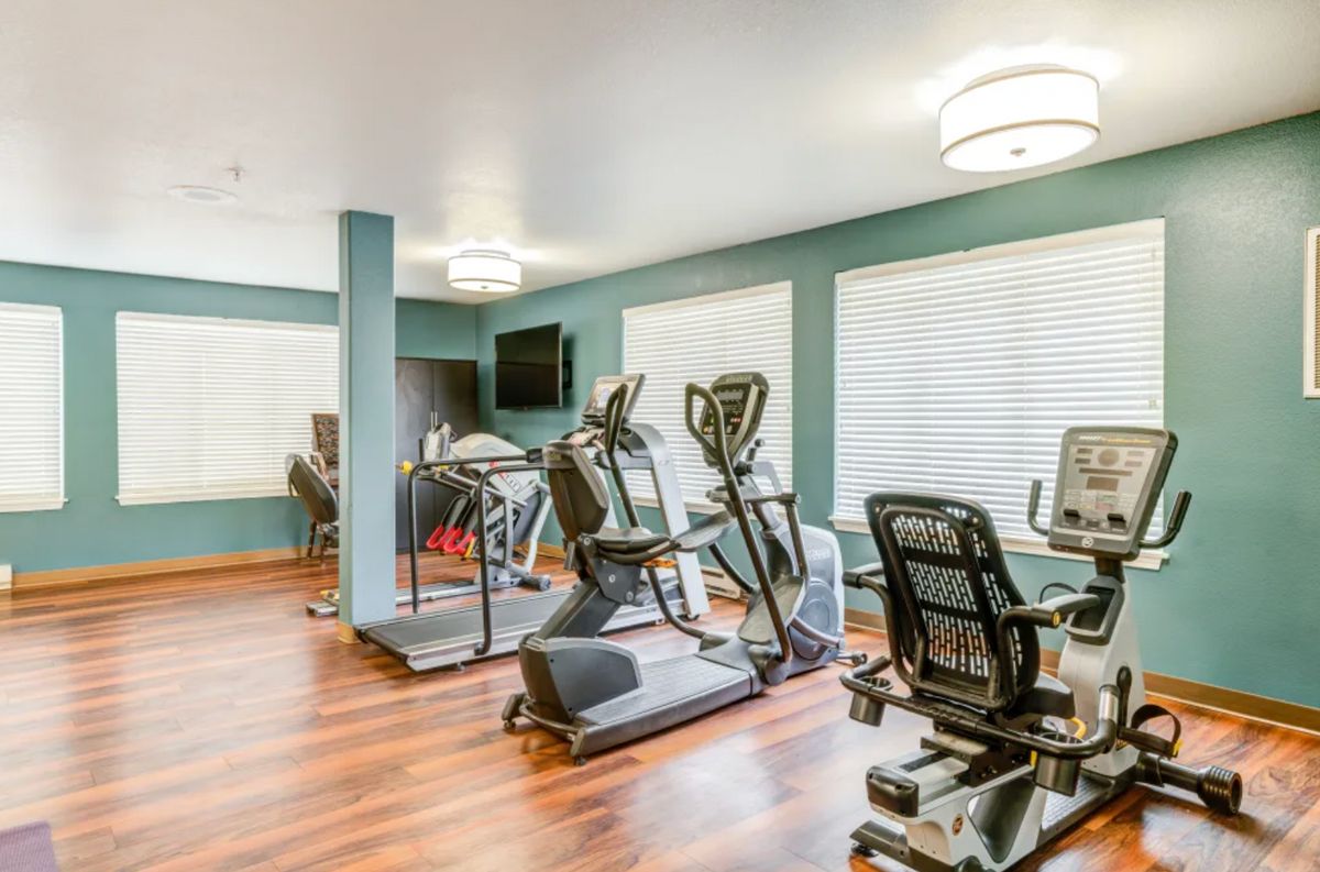 A well-equipped fitness center featuring treadmills, ellipticals, and stationary bikes.