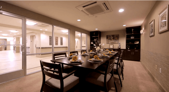 A modern and elegantly decorated dining room with a set table ready for guests.