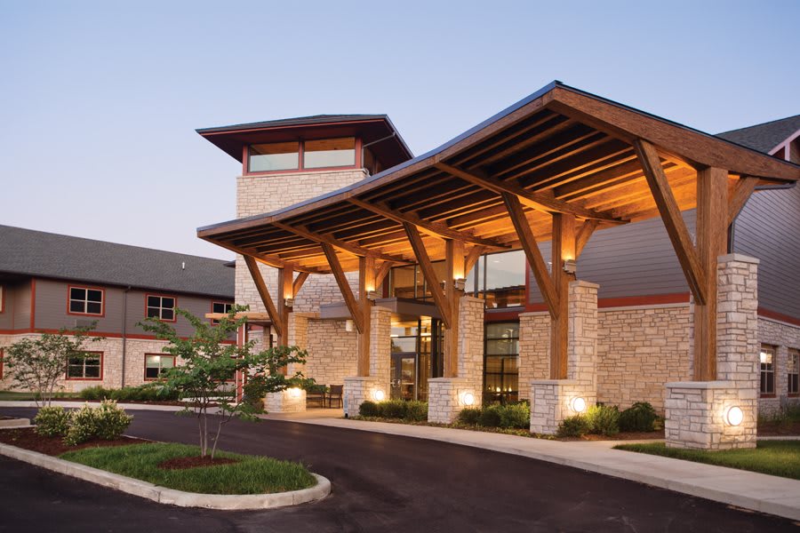 A modern building entrance featuring wood and stone design elements.