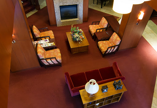 A cozy living room setup featuring comfortable seating and a welcoming fireplace.