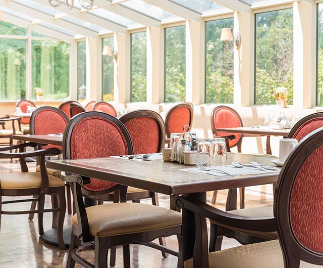 A bright and airy restaurant dining area with elegant tables and chairs.
