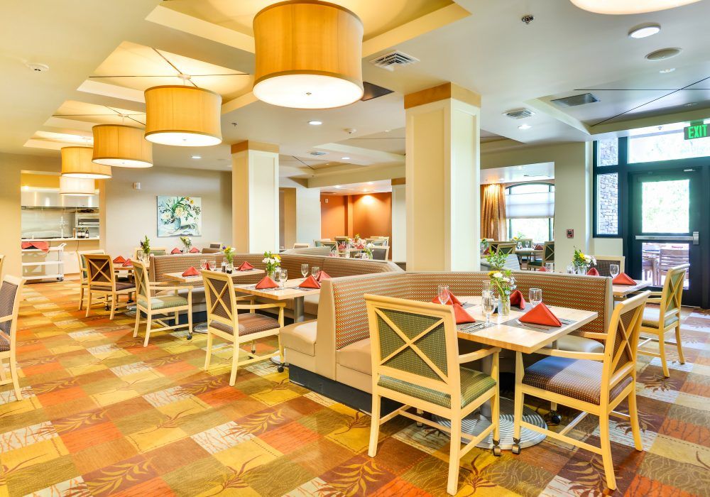 A modern restaurant interior with neatly arranged tables and comfortable seating.