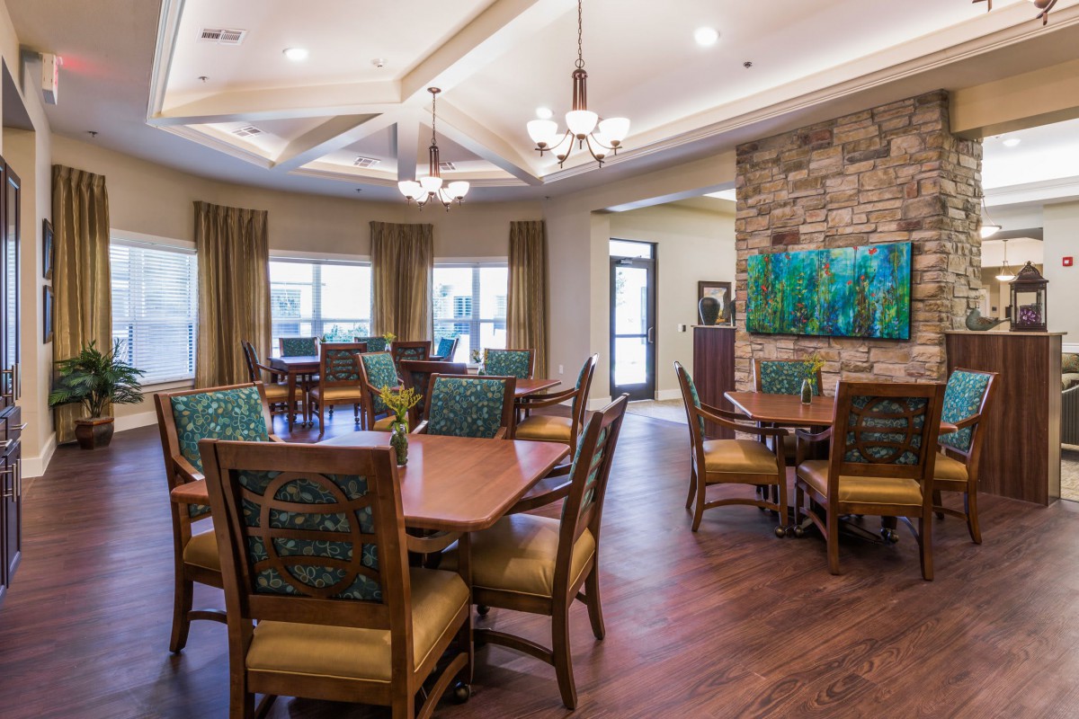 A modern dining area with elegant furnishings and warm lighting.