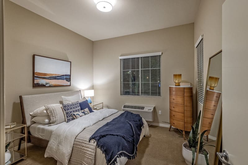 A modern, minimalist bedroom with neutral colors and simple decor.