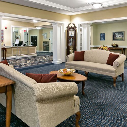 A hotel lobby with elegant sofas, a wooden table, and decorative elements.