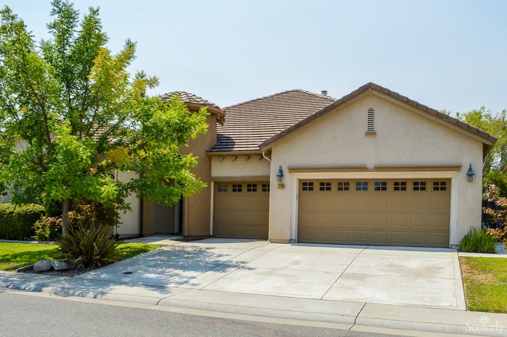 A suburban house with a two-car garage and a driveway.