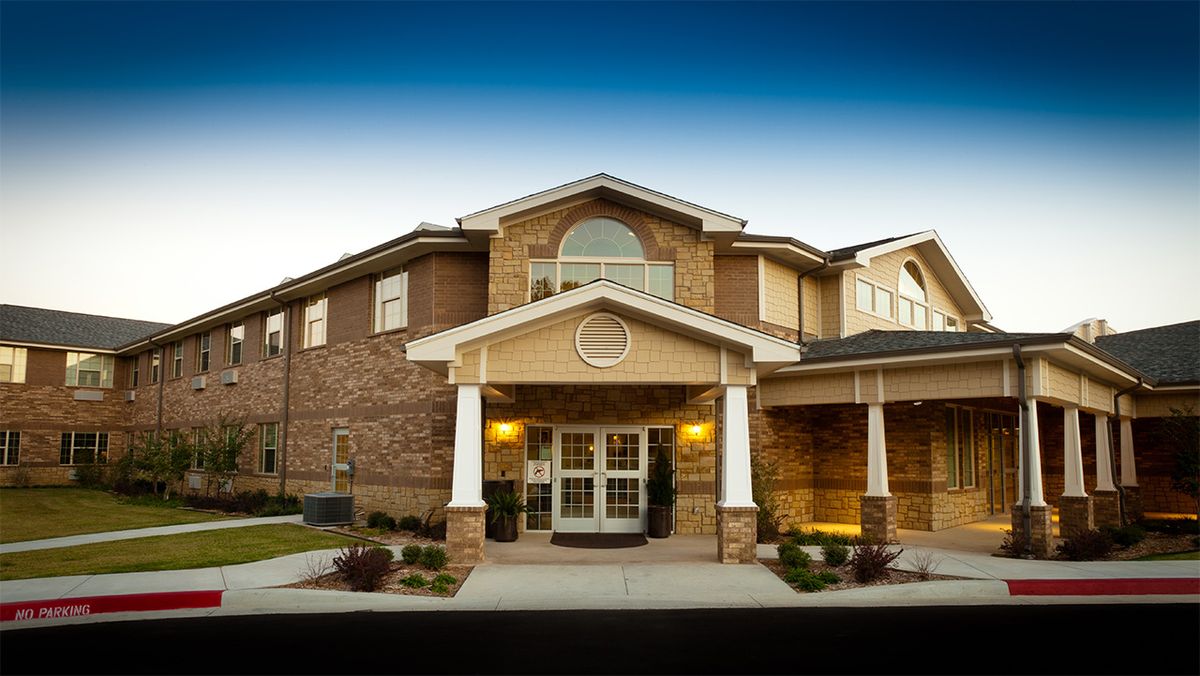 A two-story brick building with a prominent entrance.