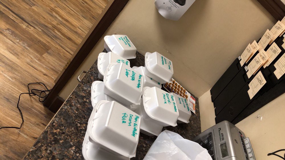 Stacked takeout containers on a counter.
