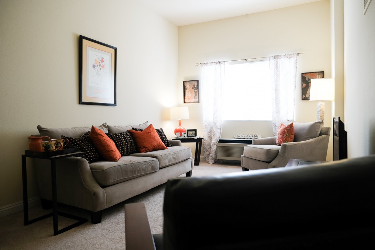 A cozy living room with comfortable sofas and warm lighting.