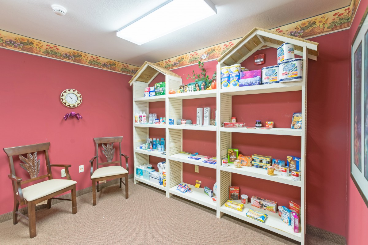 A small pharmacy with organized shelves displaying various healthcare products.
