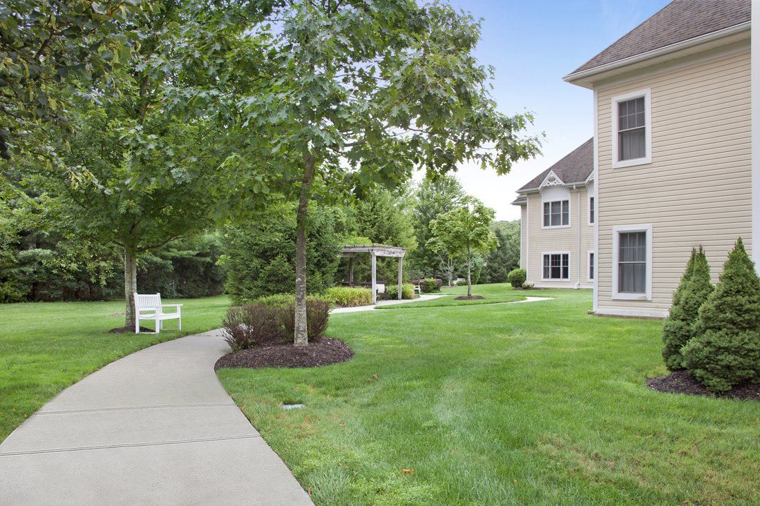 A serene garden path next to a residential building.