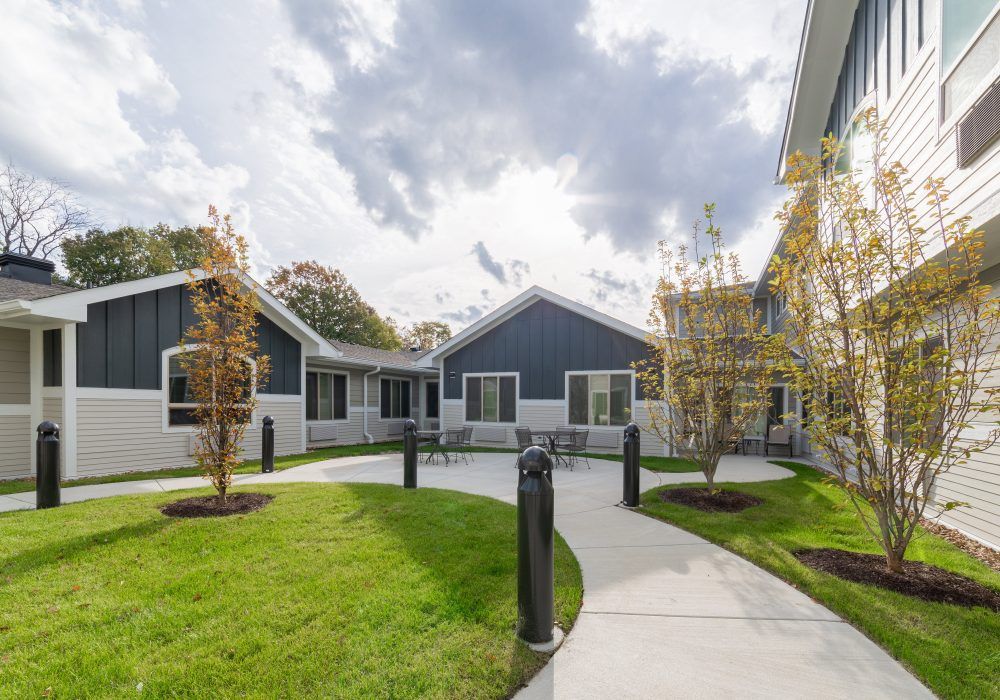 A modern residential area with a landscaped courtyard and pathway.
