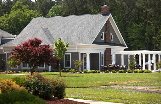 A beautiful modern house surrounded by a well-kept garden.