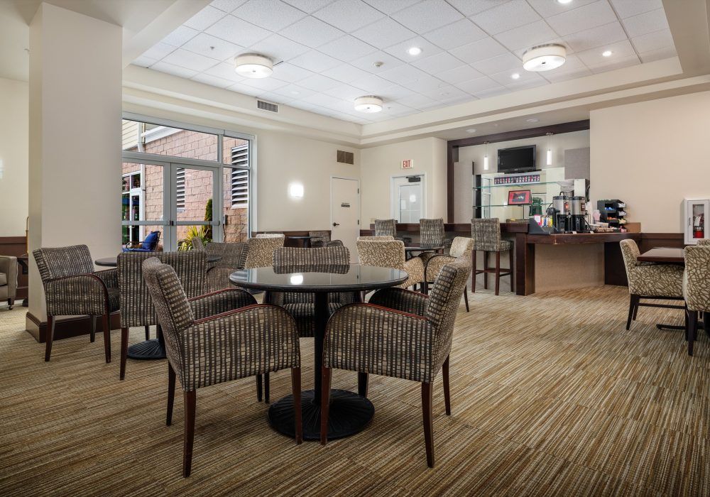 A modern lounge area with comfortable seating and a bar.