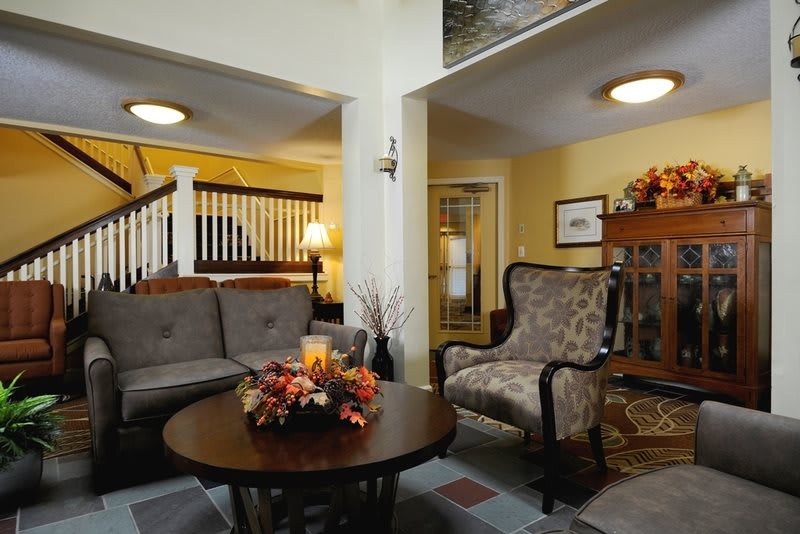 Cozy living room with comfortable seating and autumn-themed decorations.