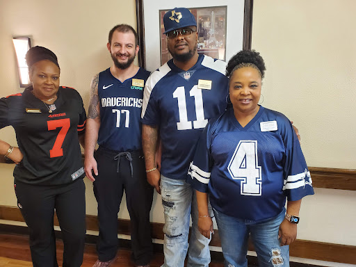 A group of friends showing their team spirit in sports jerseys.