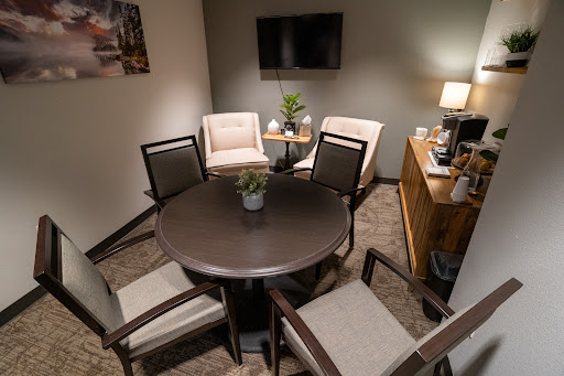 A cozy meeting space with a round table and comfortable chairs, perfect for discussions.
