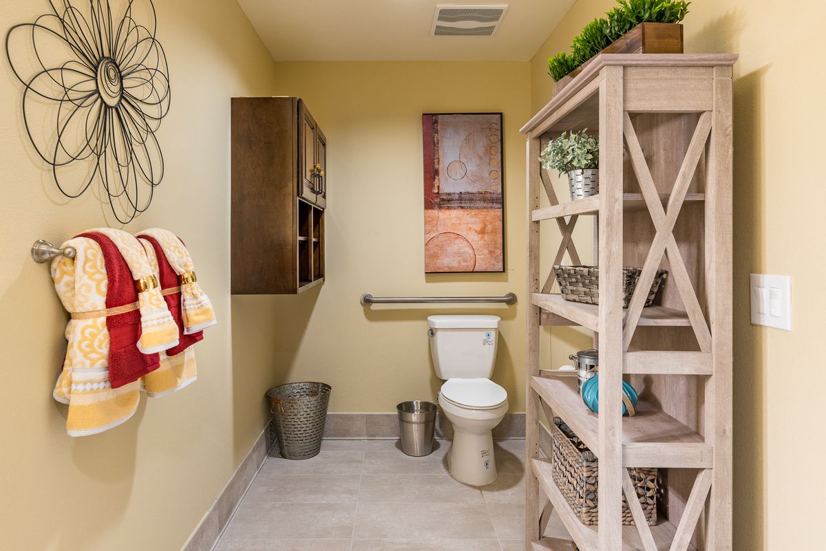 A well-decorated bathroom with shelving and modern fixtures.