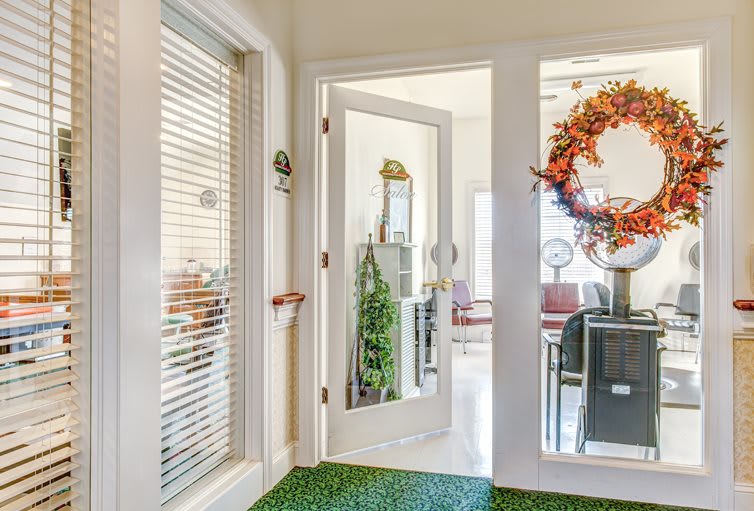 A cozy office interior featuring a decorated door with an autumn wreath.