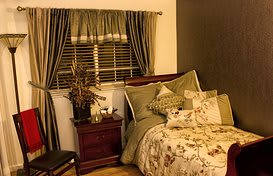A cozy bedroom with elegant decor and warm lighting.