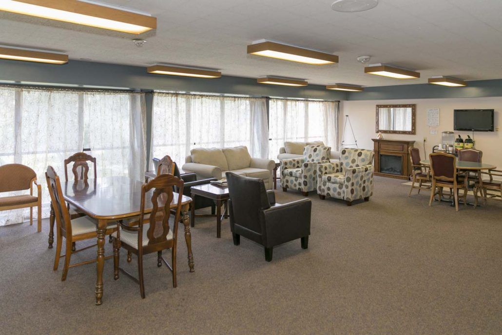 A communal lounge area with various seating options and tables.