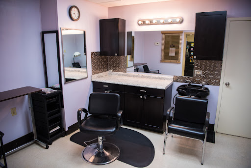 A well-equipped hair salon featuring a stylish setup for haircuts and styling.