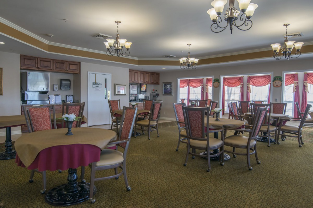 A cozy dining area with multiple tables and elegant lighting.