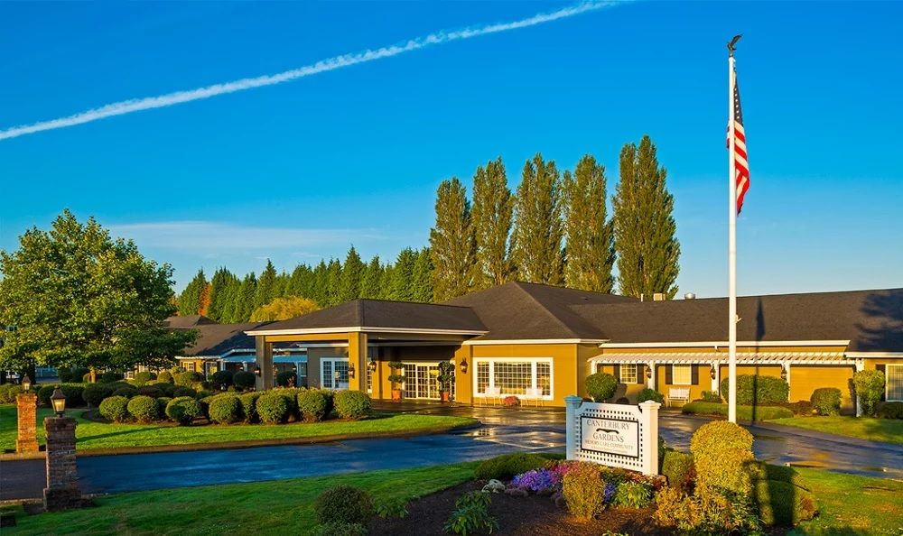 A healthcare facility surrounded by well-maintained landscaping on a clear day.