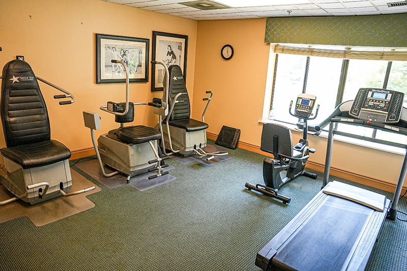 A small fitness room with various exercise equipment, including a stationary bike.