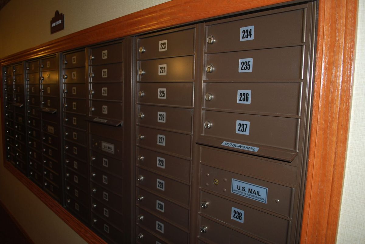 A row of brown apartment mailboxes with individual locks.