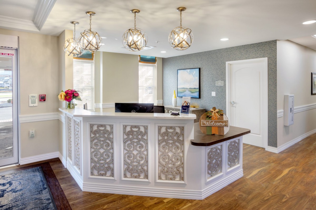 A stylish and modern reception area with decorative paneling and elegant light fixtures.