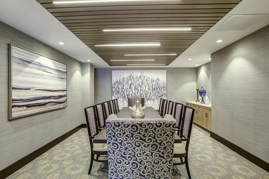 A modern dining room with sleek furnishings and elegant artwork.