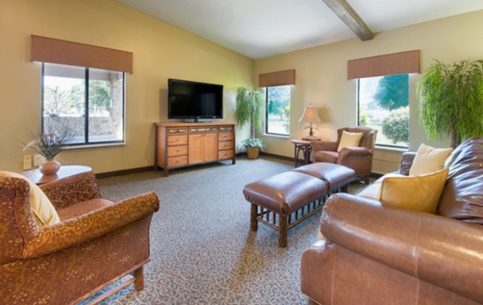 Spacious living room with comfortable seating and a television.