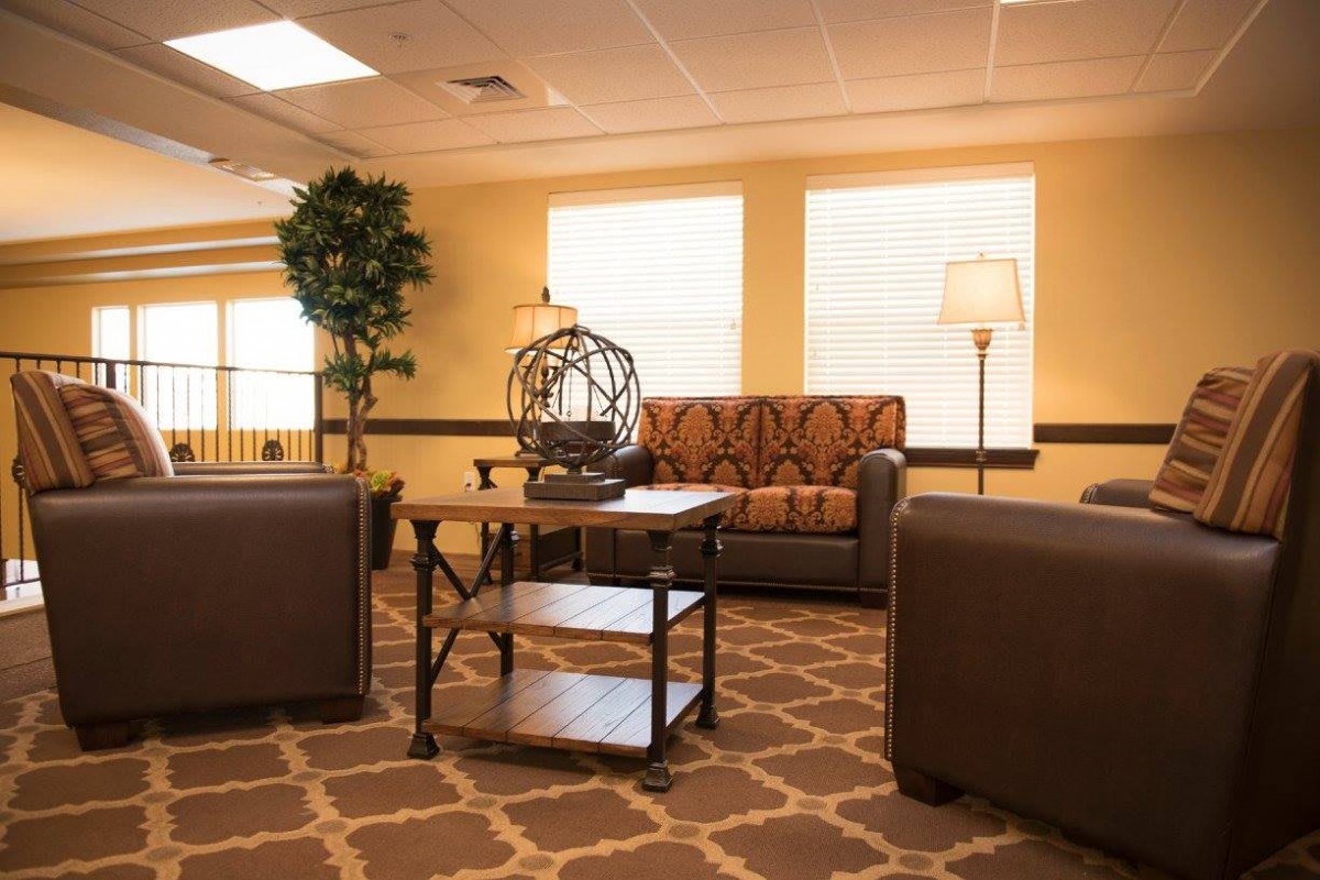A cozy living room with comfortable seating and warm lighting.