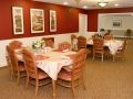 A cozy dining area with set tables and comfortable seating.