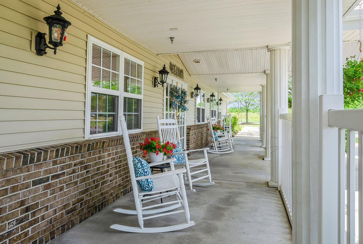A charming porch with rocking chairs and potted plants, perfect for relaxing.