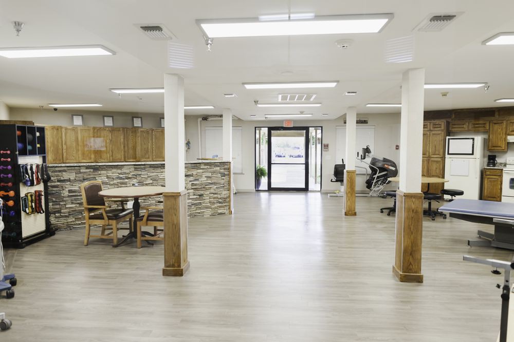 A modern office reception area with bright lighting and wooden finishes.