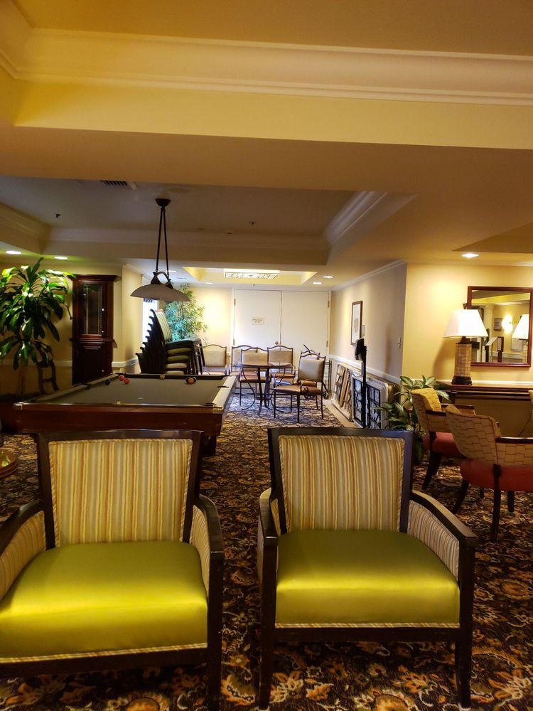 A cozy lobby area featuring seating, plants, and ambient lighting.