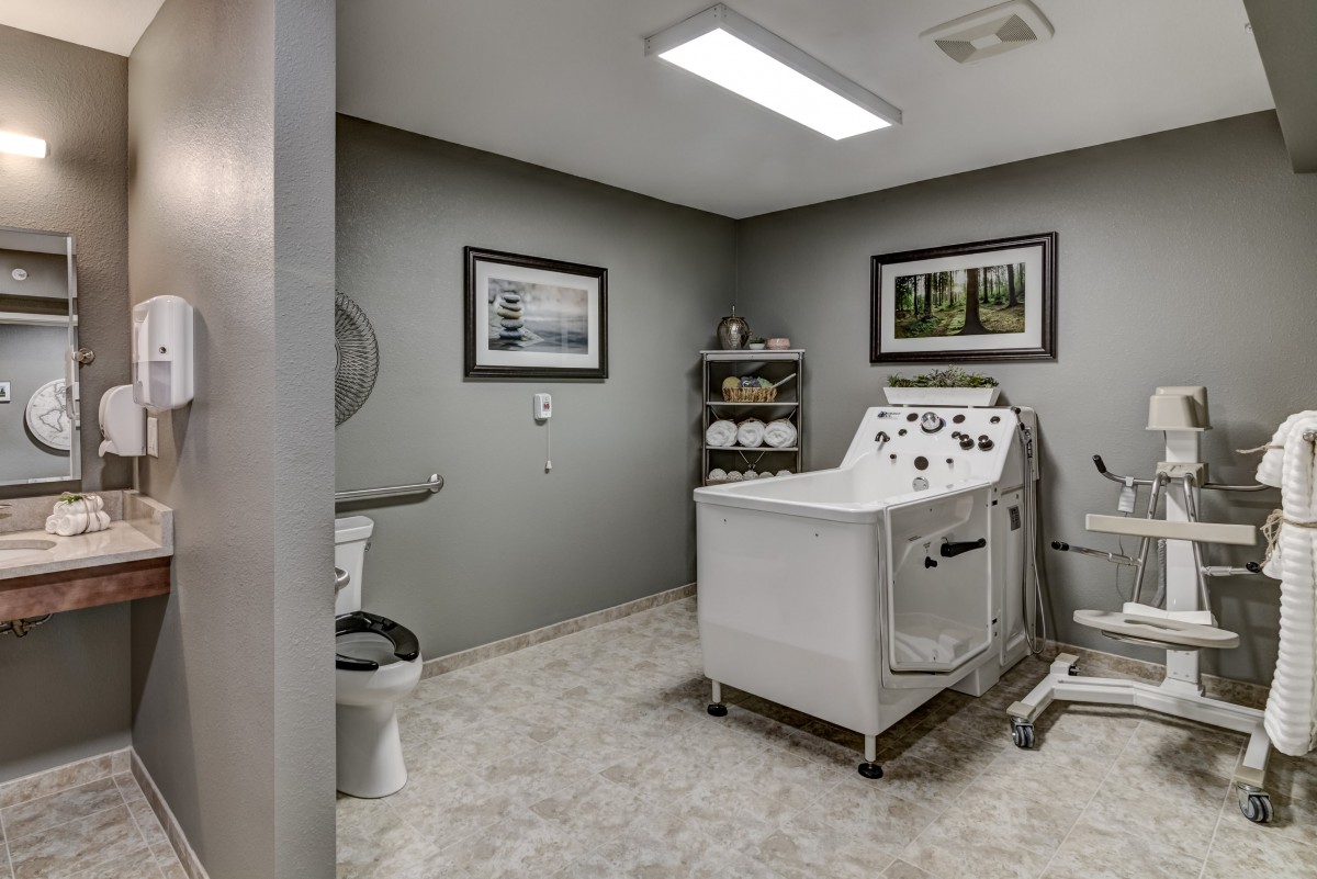 A modern spa treatment room with a massage table and soothing decor.