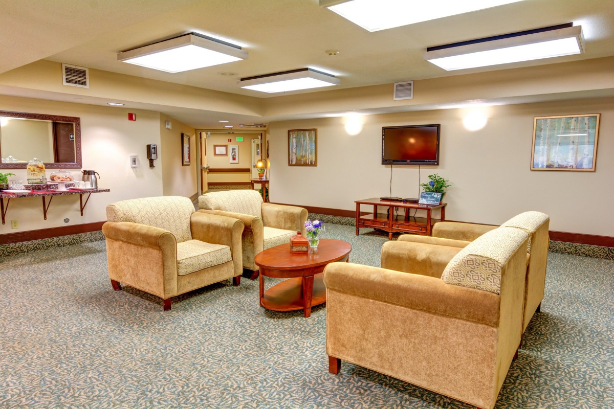 A cozy lobby area with comfortable seating and a television.