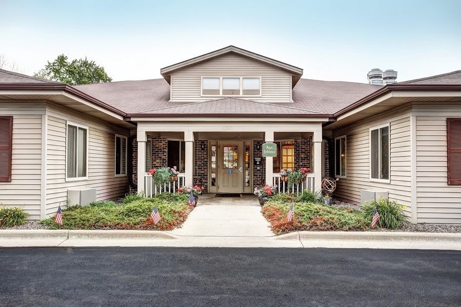 A well-maintained building entrance with surrounding landscaping.