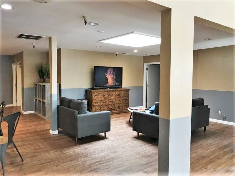 A modern living room with comfortable seating and a large television.