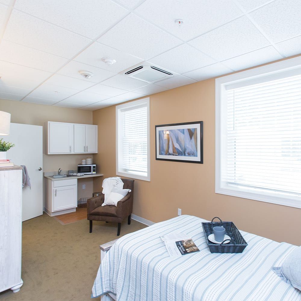 A serene and minimalist massage therapy room with soft lighting and comfortable furnishings.