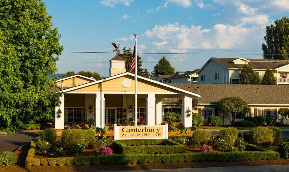 Entrance of Canterbury Village with well-maintained landscaping and a prominent sign.