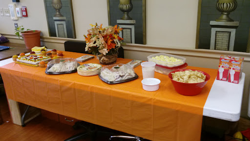 A beautifully arranged buffet table featuring a variety of dishes, adorned with autumn-themed decorations.