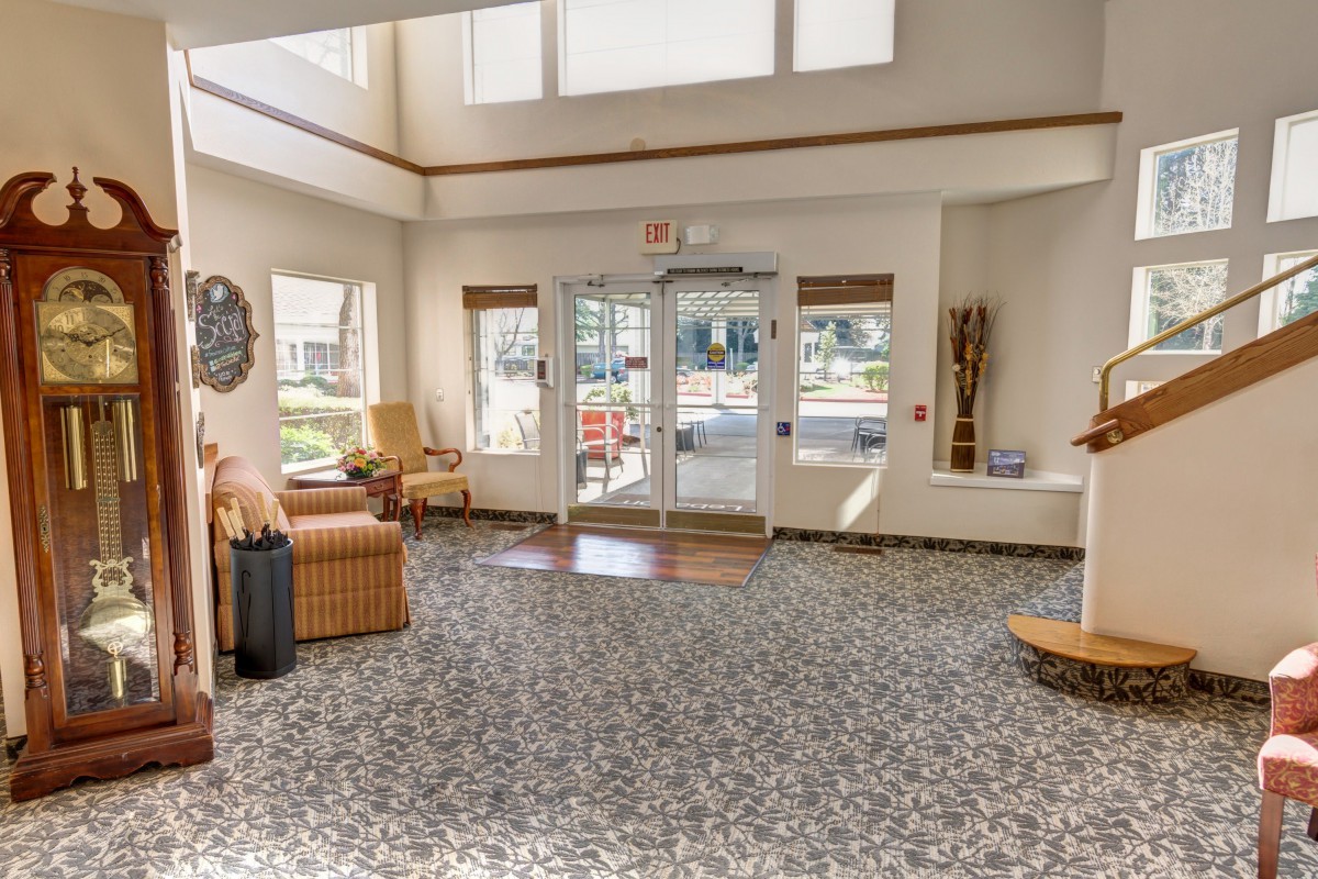 A well-lit lobby featuring comfortable seating and large windows.