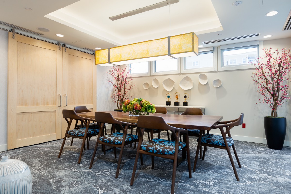 A modern dining room with a wooden table, contemporary chairs, and stylish decor.