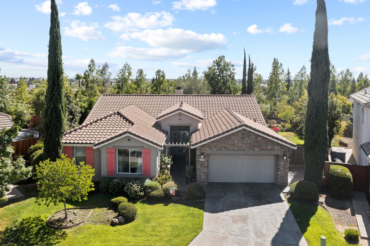 A single-story suburban house with a garage and well-maintained front yard.