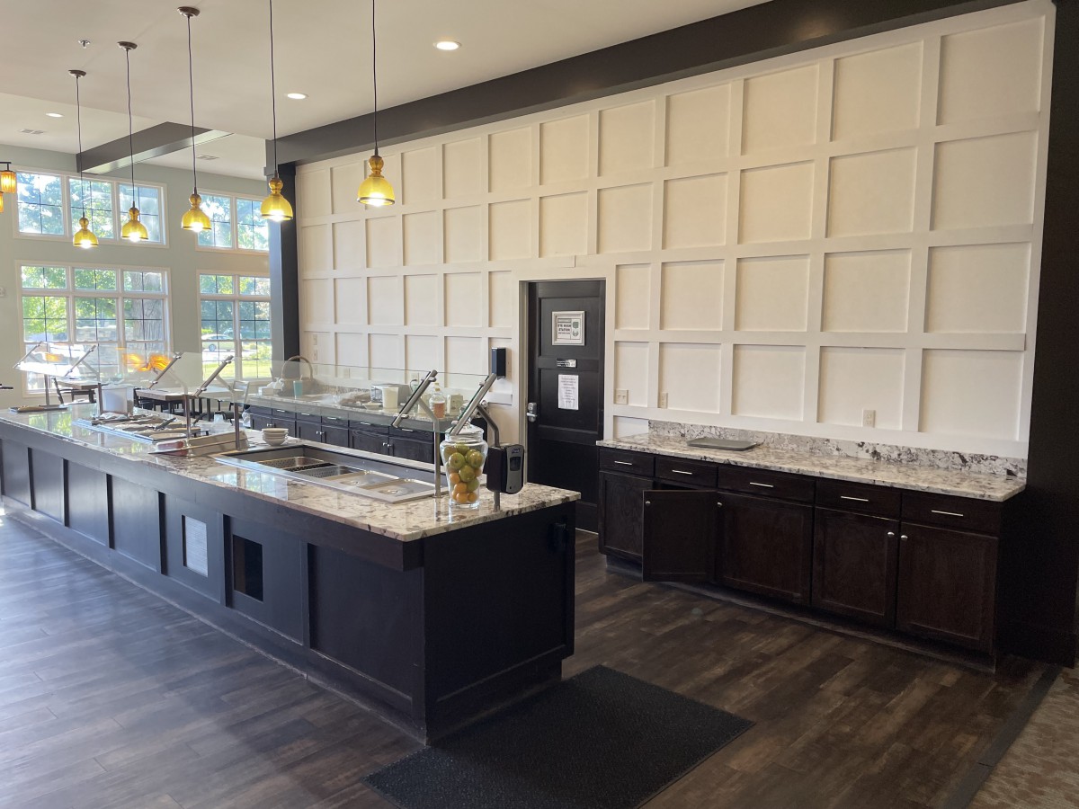 A modern kitchen interior with an island and stylish lighting.